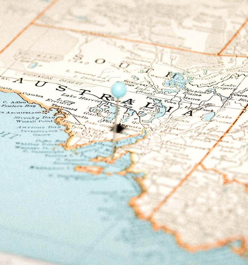 Close-up of a map focusing on South Australia, with a pin marking Port Adelaide. The map shows coastline and geographical details in muted blue and beige tones.