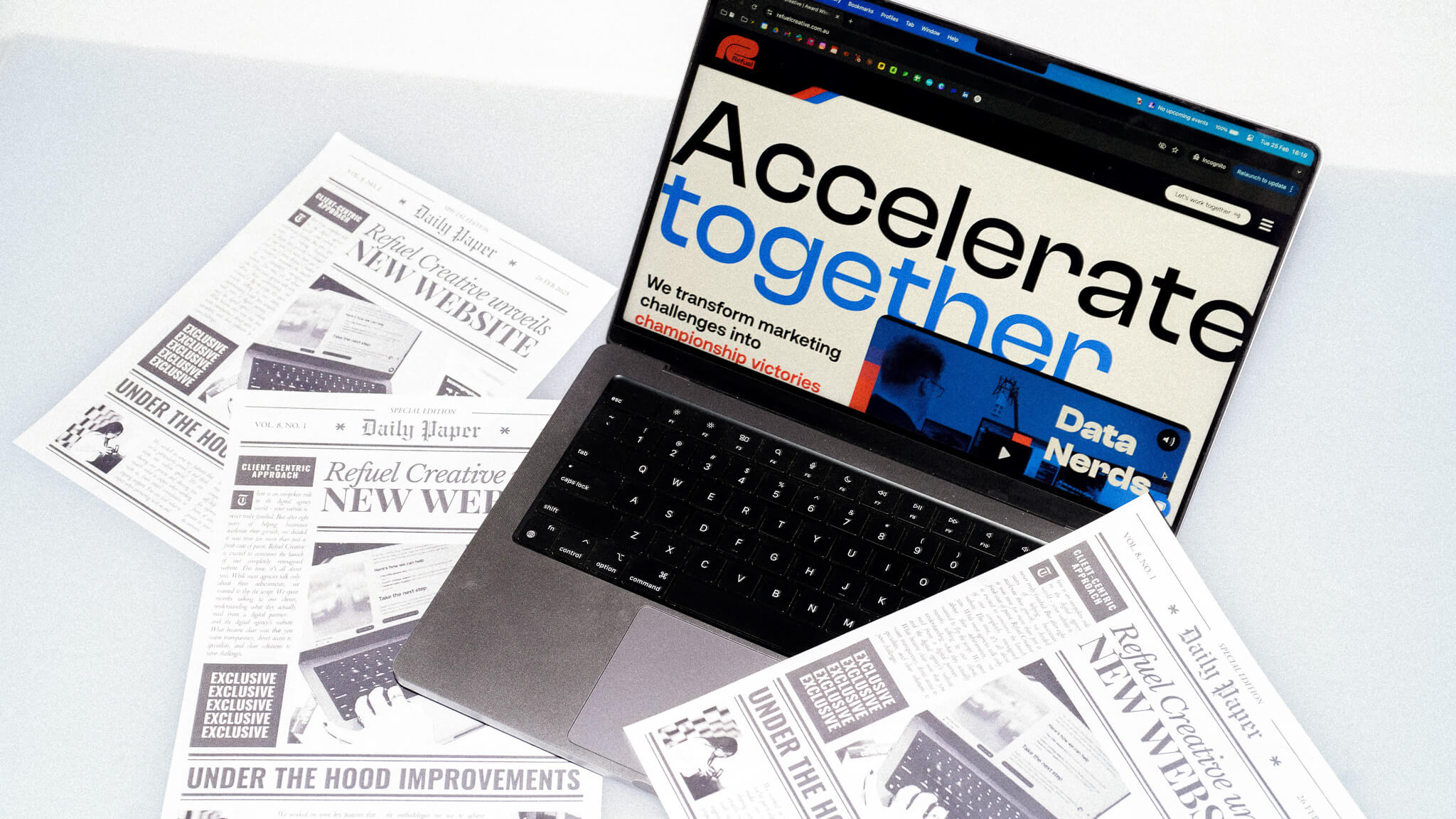 Refuel Creative website shown on a laptop with news articles announcing the redesign around it