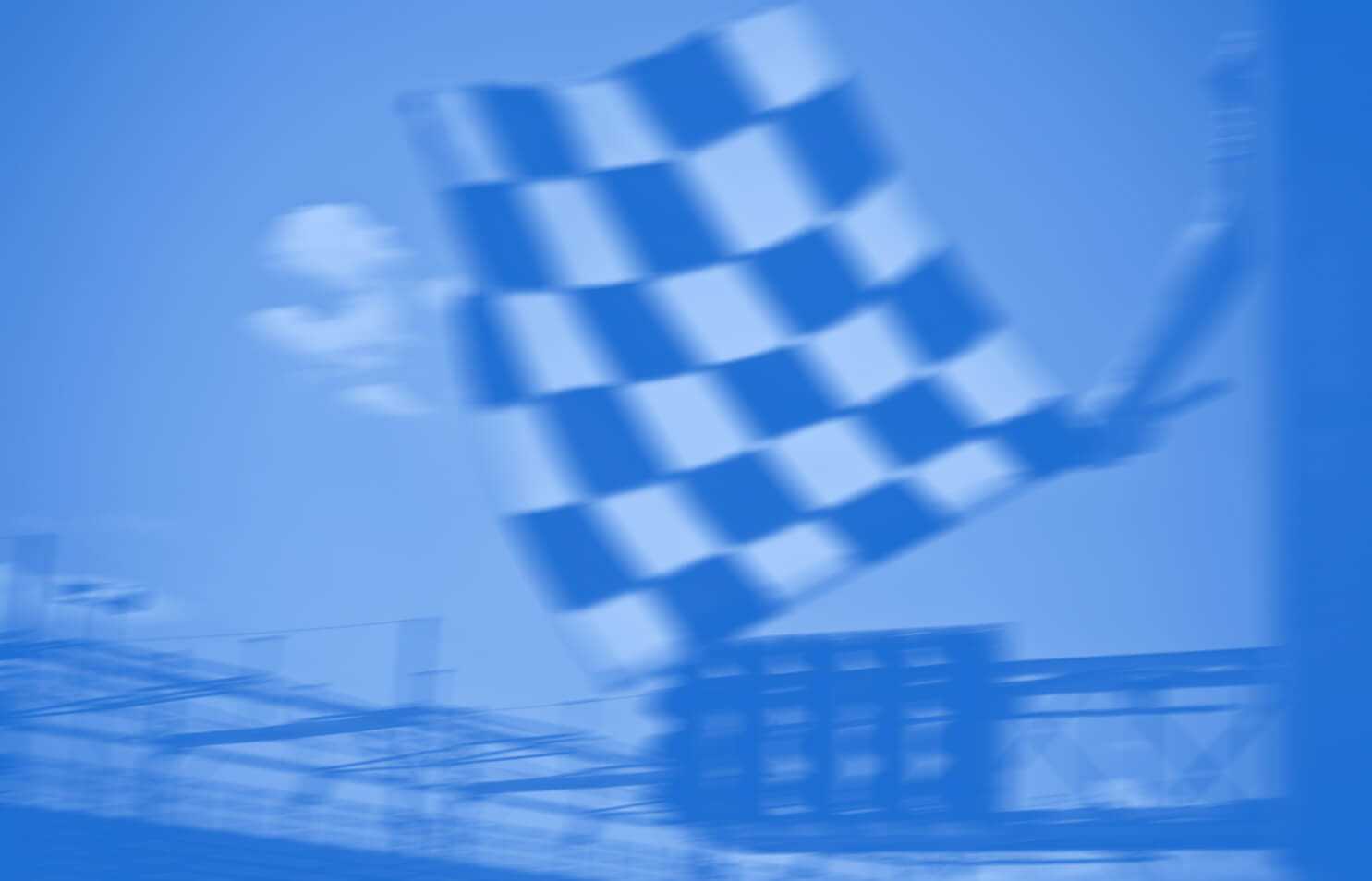 Checkered flag being waved at car race