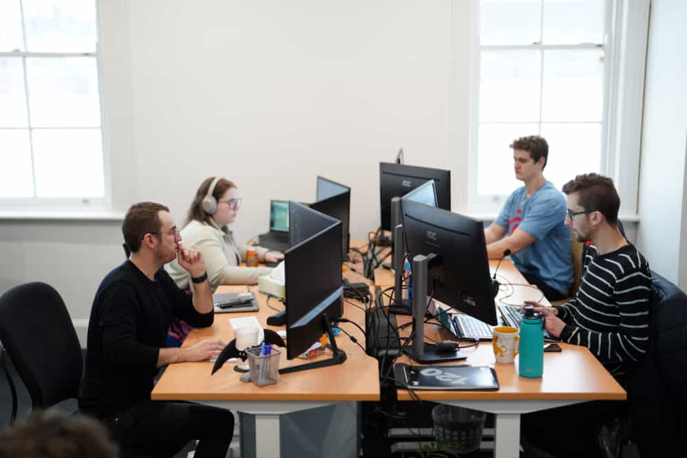 office-workers-sitting-at-their-desks-looking-at-computers