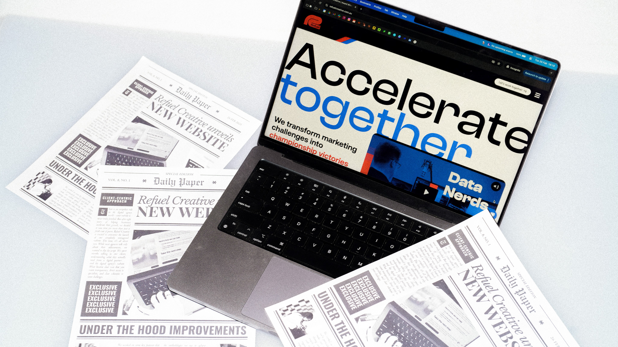 Refuel Creative website shown on a laptop with news articles announcing the redesign around it