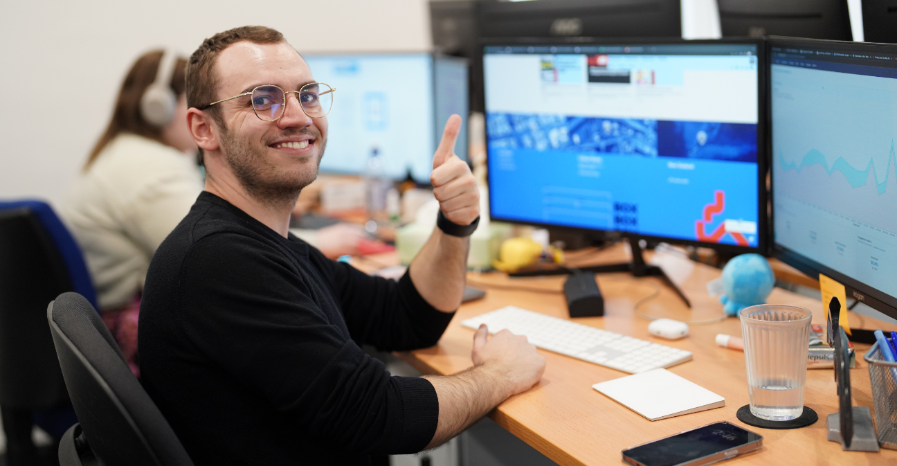 Worker-at-computer-giving-thumbs-up